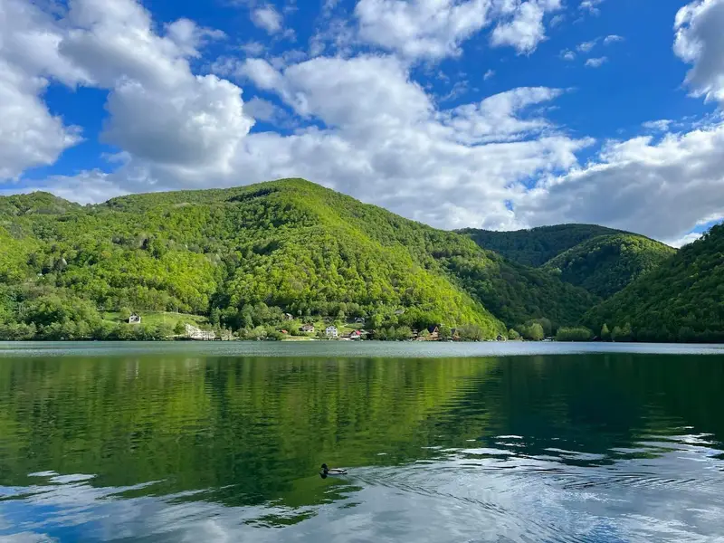 Plivsko jezero među zelenim brdima, s kućama na obali